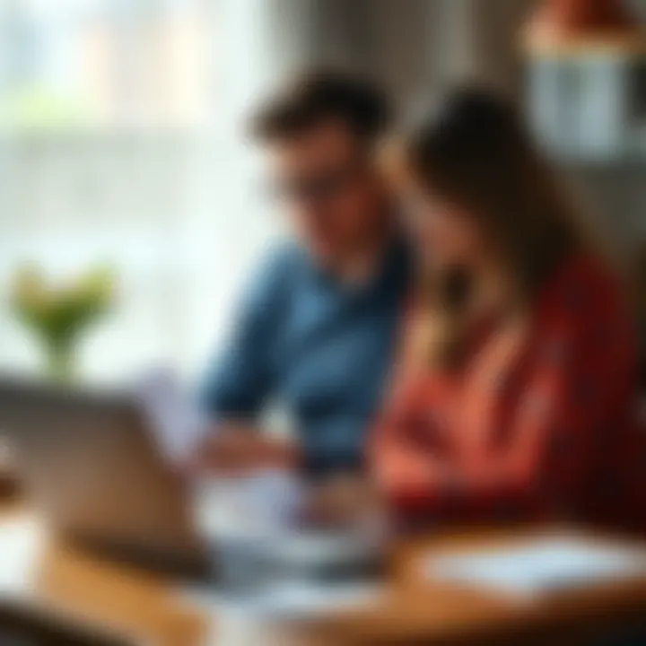 A man and woman sitting together at a table, having an emotional conversation about finances with papers and a laptop in front of them.