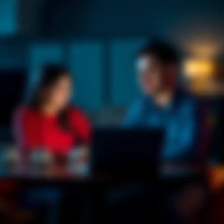 A couple sitting at a table, looking at a laptop with Bitcoin graphs on the screen, discussing their investment options.
