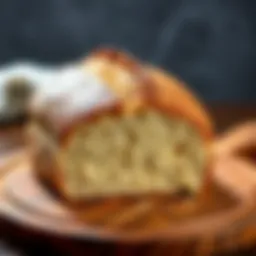 A golden-brown sourdough loaf with a soft, open crumb sitting on a wooden board