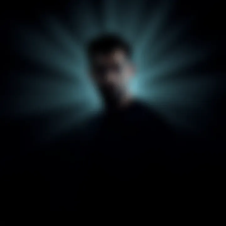 A man standing in shadows with a thoughtful expression, suggesting depth and complexity in his character.